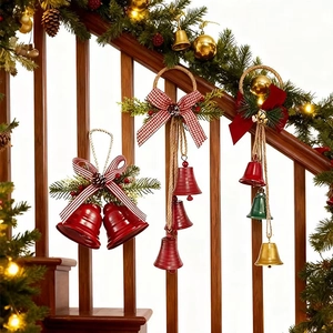 Close-up of vintage metal Christmas bells with pine cones and bows on a wooden staircase