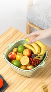 Detail of double-layer drain basket with side handles and green inner fruit bowl
