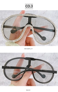 Detail view of oversized pilot sunglasses with crystal embellishments and grey lenses
