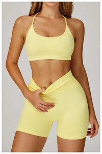 Detail of light yellow seamless yoga set featuring a ribbed v-waistband and cross neck bra