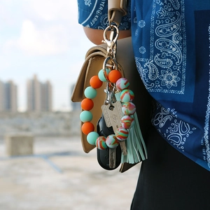 Close-up of silicone bead wristlet keychain with leather tassel and car key remote