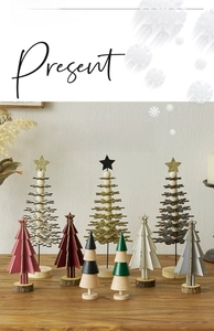 Close-up of assorted wooden Christmas tree table decorations with snowy details
