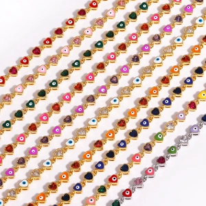 Detail of colorful heart-shaped evil eye links on gold and silver chain bracelets