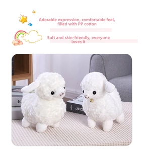 Close-up of white plush lamb toys with curly fur, golden bells and soft PP cotton filling