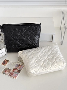 Minimalist heart quilted makeup bags in black and white with decorative pearl chain zippers