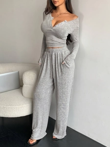 Close-up of gray knit lounge set featuring button-up top and drawstring wide-leg pants