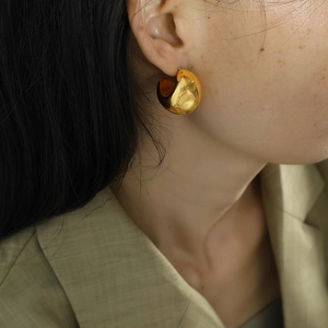Minimalist thick gold C-shaped hoop earrings with a high-polished mirror finish