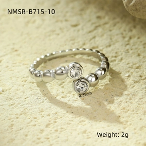 Macro shot of silver titanium ring with round cubic zirconia and 2g weight spec