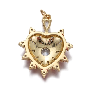Detailed view of a gold heart pendant with clear zircon inlay and red enamel back