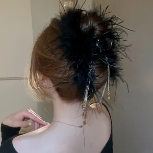 Elegant black feather hair claw clip with crystal tassels shown on back view