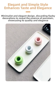 Three pastel ceramic doughnut toothbrush holders arranged on a matching white ceramic tray