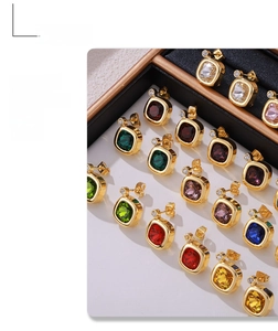 Detail view of square zircon earrings in multiple colors with gold plated metal frames