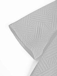 Gros plan sur un tricot gris clair avec texture gaufrée 3D géométrique et coutures