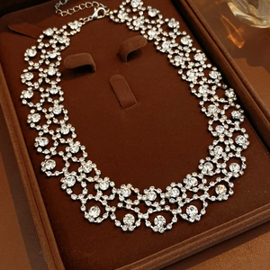 Detailed view of luxury silver-tone rhinestone choker necklace in a brown jewelry box