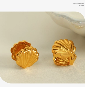 Détails macro des boucles d'oreilles coquillage dorées avec une texture rayonnante