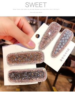 Detail of 4pcs sparkling crystal hair clips with colorful rhinestones on a card