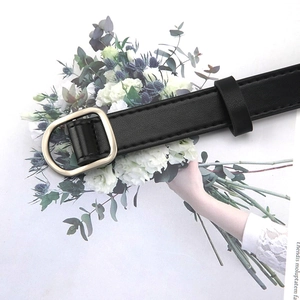 Women's thin black synthetic leather belt with a minimalist golden D-ring buckle