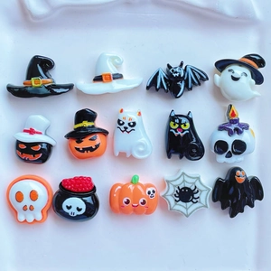 Flat lay of 15 colorful resin Halloween charms featuring pumpkins, ghosts, and witch hats