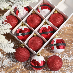 Set of 12 red festive Christmas ornaments with various patterns in a white display box