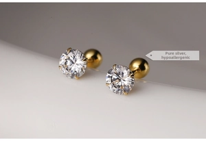 Detail of gold 925 silver stud earrings with 6-prong round zircon and ball screw back