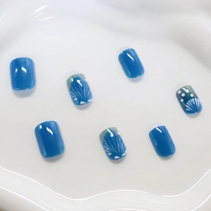 Short square press-on nails featuring minimalist blue shell texture and polka dot design