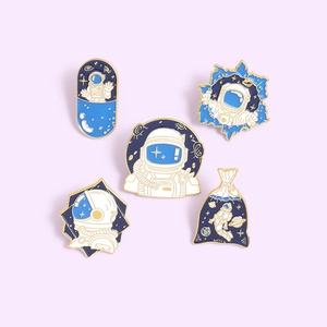 5-piece astronaut enamel pin set featuring cartoon space capsule designs with gold plating