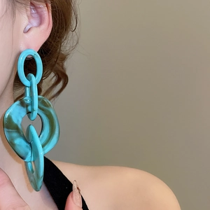 Detail of blue marble acrylic chain drop earrings with textured oversized links