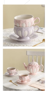Detail of pink and purple embossed ceramic tea set with cups, saucers and teapot