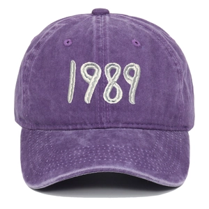 Macro detail of 1989 embroidery on a vintage washed purple cotton baseball cap