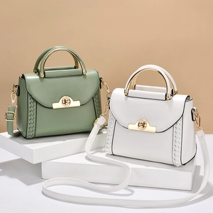 Elegant women's handbag with golden U-shaped handle and woven sides in green and white