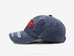 Detail view of washed navy denim baseball cap with red embroidered D and workshop brim