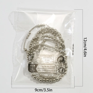 Silver bead chain bracelet with heart pendant shown in clear packaging with measurements