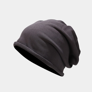 Detail of dark grey knit slouchy beanie showing texture and rolled edge design