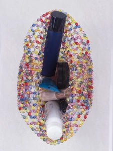 Detail of a handmade colorful acrylic beaded tote bag with a hollow woven pattern