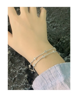Detailed macro view of S925 sterling silver beaded bracelet on a woman wrist