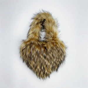 Macro detail of heart-shaped faux fur handbag with leopard animal print texture