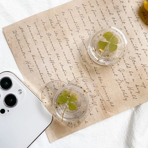 Detail of heart and round phone sockets with real clover leaves and gold foil flakes