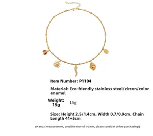 Macro detail of 18k gold plated necklace with zircon charms and red enamel ladybug pendant
