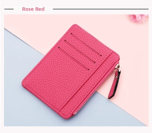 Detail of rose red ultra-slim card holder with three slots and a zippered coin pocket