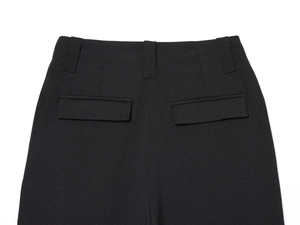 Close-up of black wide-leg pants back view showing waist loops and dual flap pockets