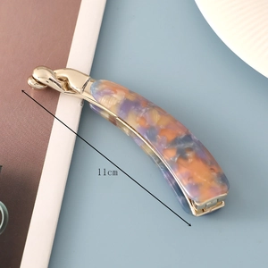 Detail view of 11cm banana hair clip showing purple marble texture and gold metal hinge