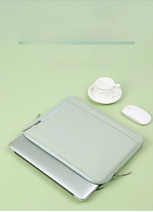 Light green waterproof laptop sleeve with double zippers and front accessory pocket