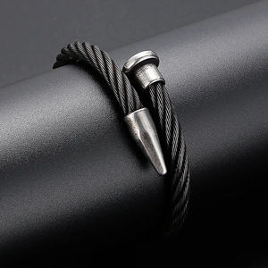 Macro detail of industrial black cable bracelet with vintage silver nail head accents