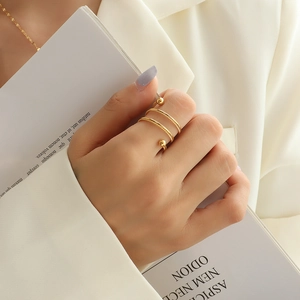 Three-layer golden spiral open ring with twist texture and ball accents on fingers