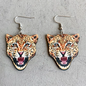 Detailed view of leopard-shaped wooden drop earrings with durable metal hooks