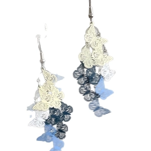 Resin butterfly tassel earrings in blue and white cream colors with layered floral design
