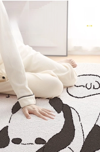 Detail of soft thick plush panda rug showing high density furry texture and hand comfort