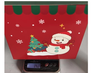 Detailed view showing the 142g weight of the festive red snowman Christmas gift box