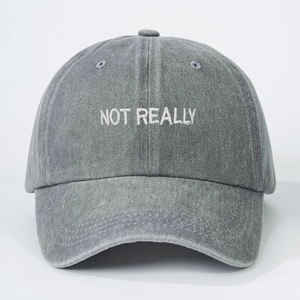 Dark grey washed denim baseball cap featuring white 'NOT REALLY' embroidery for casual wear