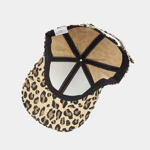 Detail view of cotton baseball cap interior featuring cow print and adjustable strap